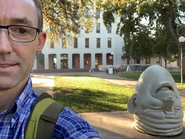 Marcel Holyoak and egghead statue